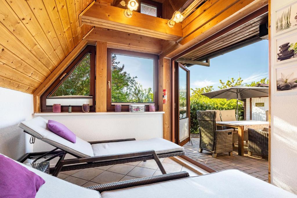 a room with a balcony with a chair and a table at Arosa in Bachenbrock