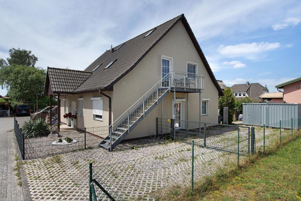 a house with a staircase on the side of it at Abendsonne in Koserow