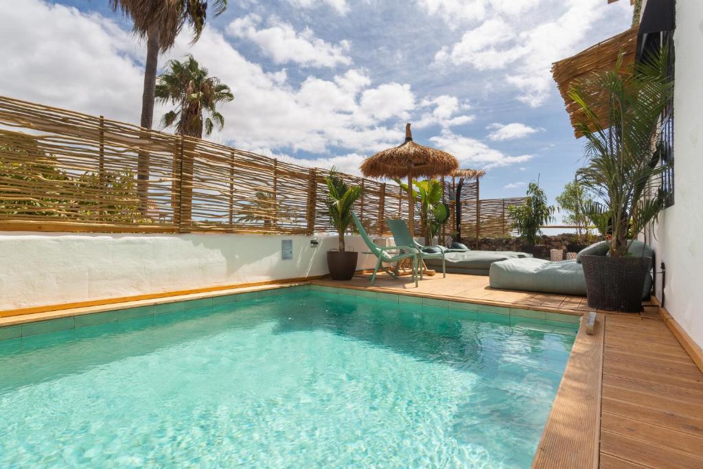 a swimming pool in a house with a patio at Oceania Villa B, Private Pool in Chayofa