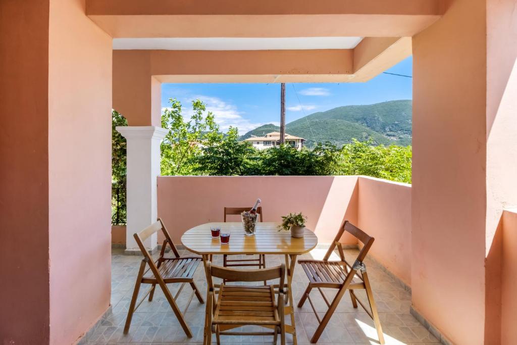 a table and chairs on a balcony with a view at Apollon Apartment in Póndi