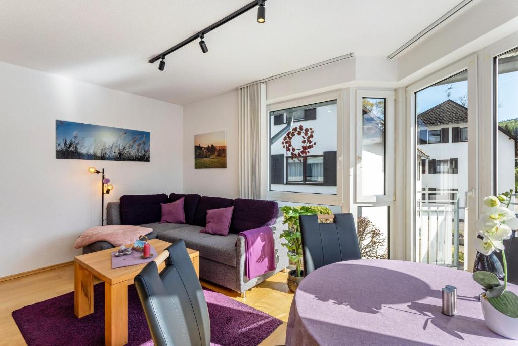 a living room with a couch and a table at Fewo Willingenliebe Meinecardplus in Willingen
