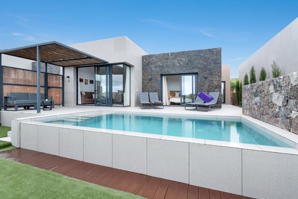 a swimming pool in the backyard of a house at Yucas Villa 14 in San Bartolomé