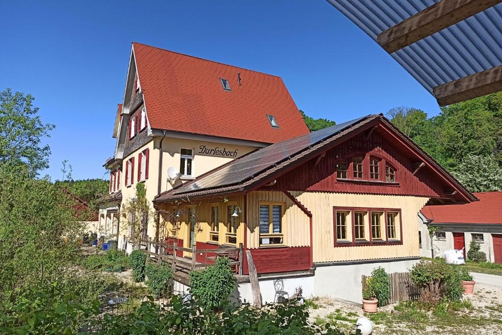 a large building with a red roof at Bahnhof Durlesbach in Bad Waldsee