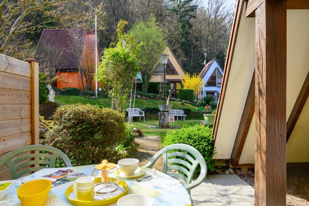a table and chairs on a patio with a view of a yard at Gite Gewurz n°4 à Kaysersberg in Kaysersberg