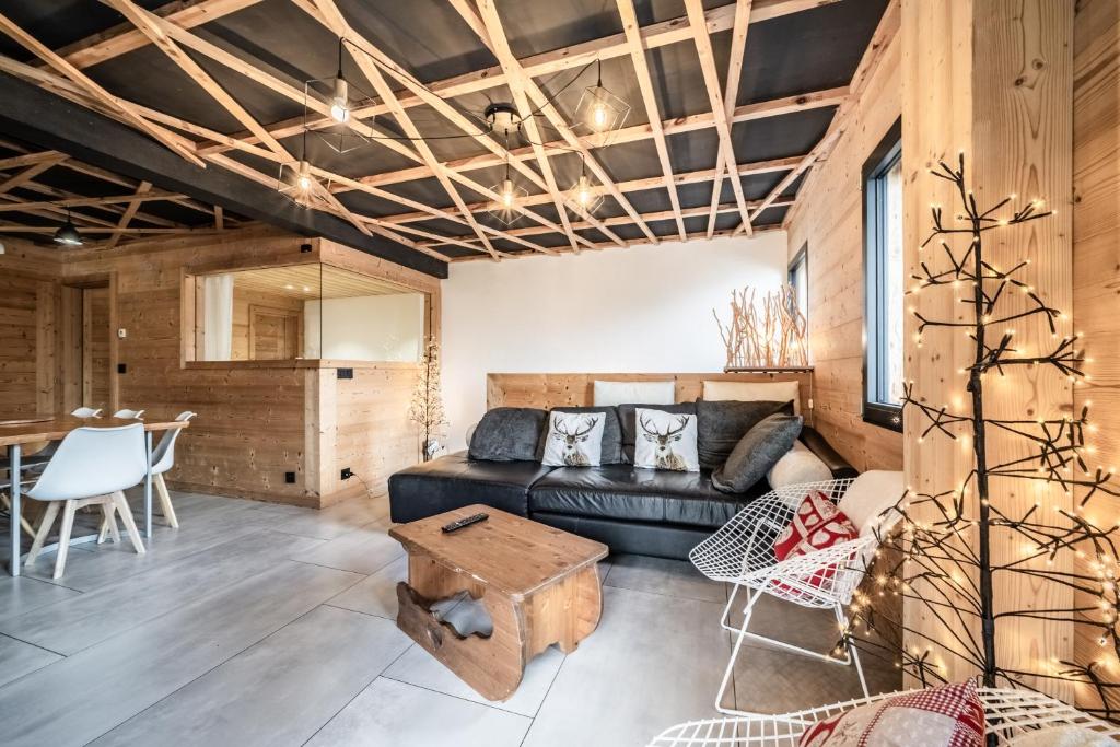 a living room with a couch and a table at Martonne Terrasse chatel Roca in Châtel