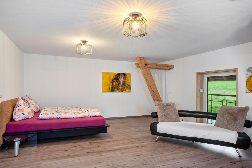 a room with a bed and a cross on the wall at Salerhof in Bad Wurzach