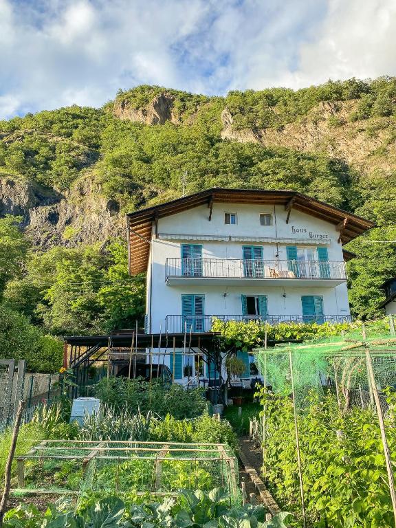 a building with a hill in the background at Haus Burger Vilpian in Vilpiano