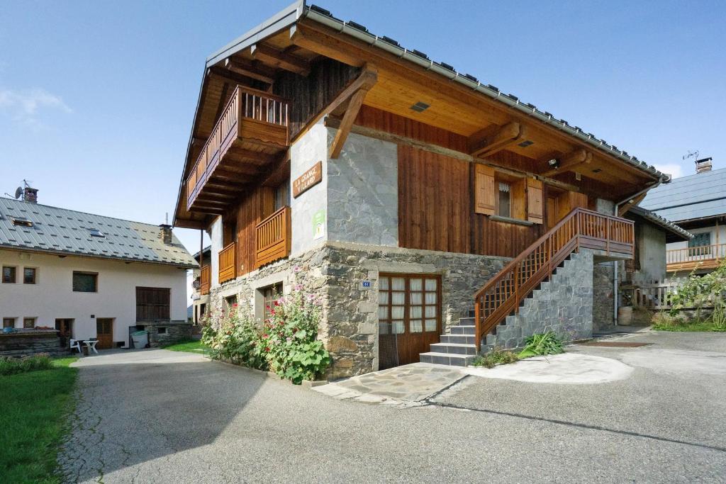 a large house with a staircase on the side of it at La Grange Villard in Albiez-Montrond