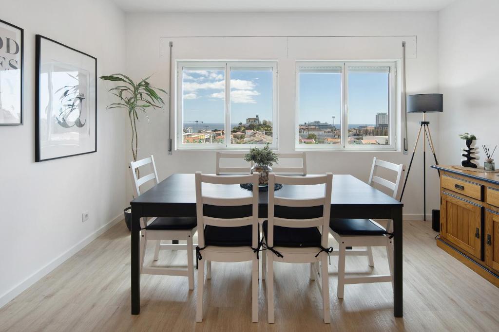 a dining room with a black table and chairs at Ocean City View Loft in Ponta Delgada