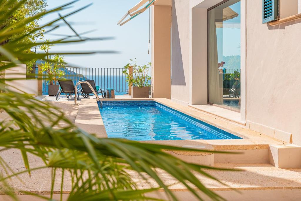 a swimming pool in a villa with a view of the ocean at Casa del Puerto in Port de Soller