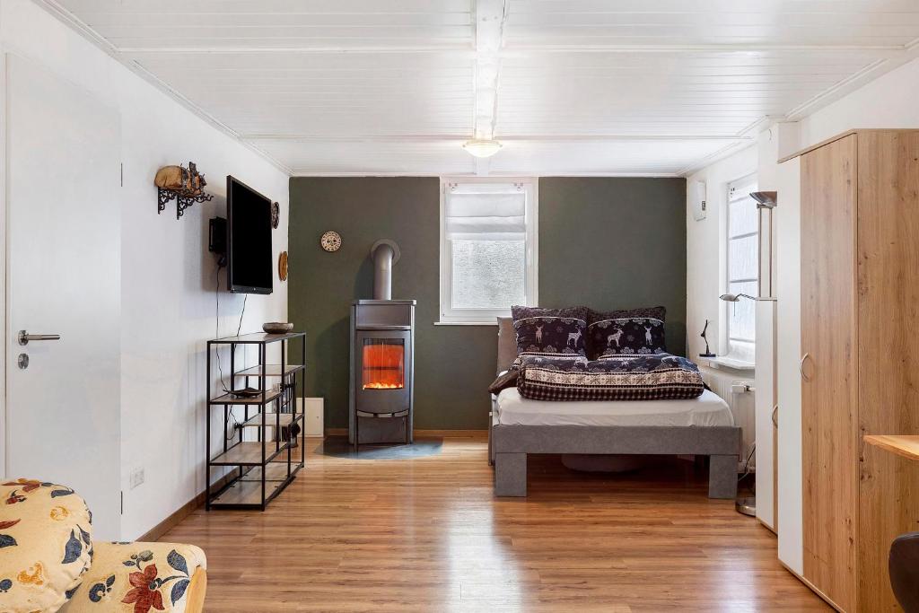 a bedroom with a bed and a fireplace in it at Ferienwohnung Donauherz in Stetten