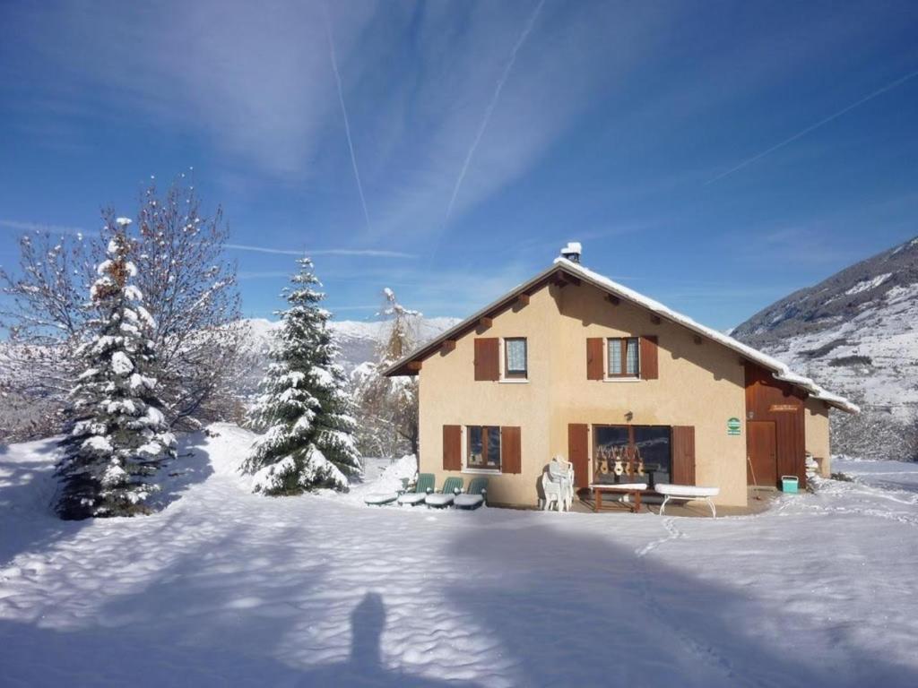 a house in the snow with snow covered trees at Chalet St Victoire - Les Orres in Les Orres
