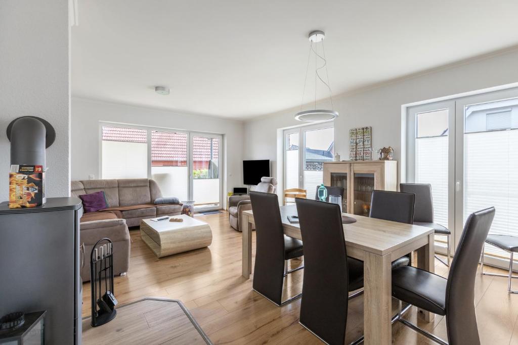 a living room and dining room with a table and chairs at Ferienhaus Manni Eg in Büsum