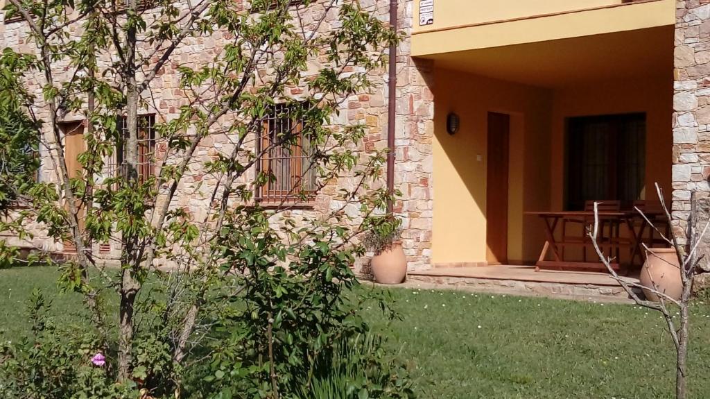 a brick building with a table in a yard at Apartament Can Pujadas in Regencós