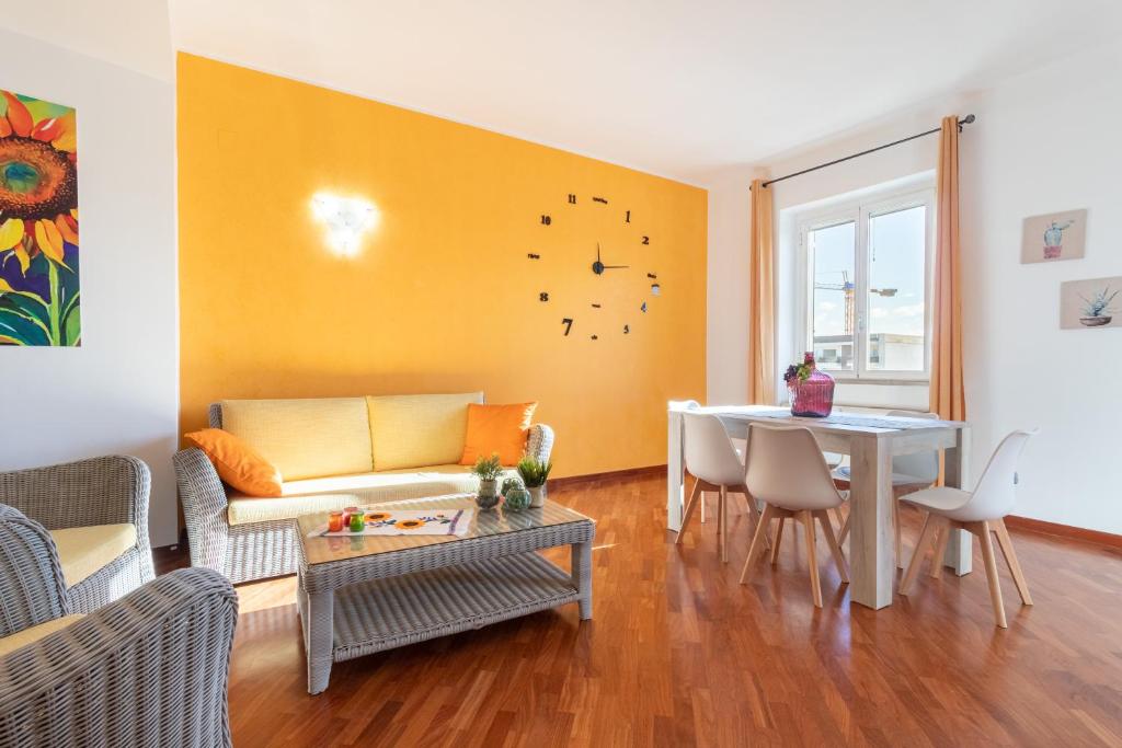 a living room with a couch and a table at Sole e Girasoli in Molfetta