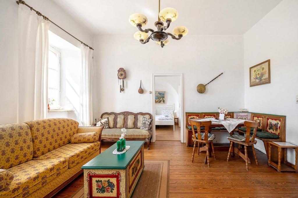 a living room with a couch and a table at Ferienwohnung Abtei Klosterhof in Maring-Noviand