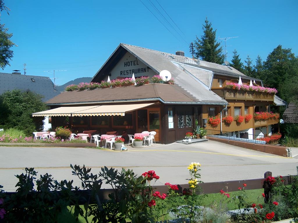 a restaurant with tables and chairs in front of it at Hotel Bären - drei Sterne in Bernau im Schwarzwald