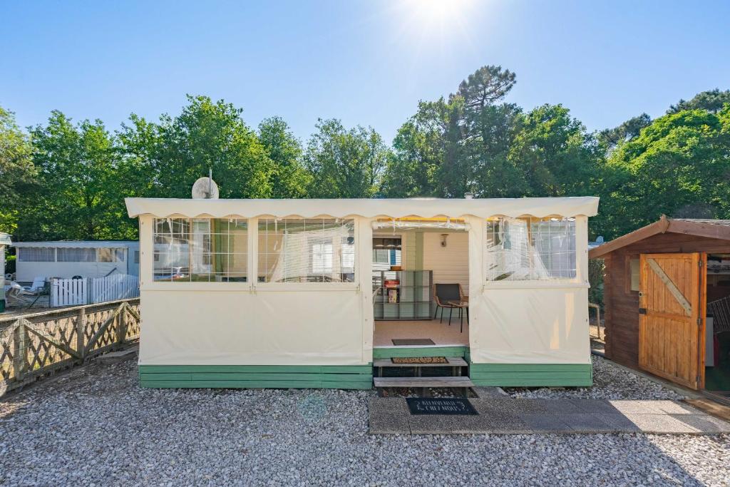 a gazebo with a porch in a yard at Mobilhome Mh 212 in La Tremblade