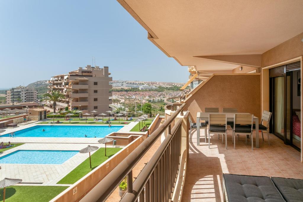 a balcony with a view of a swimming pool at Luxury flat beach ressort sea view in Arenales del Sol