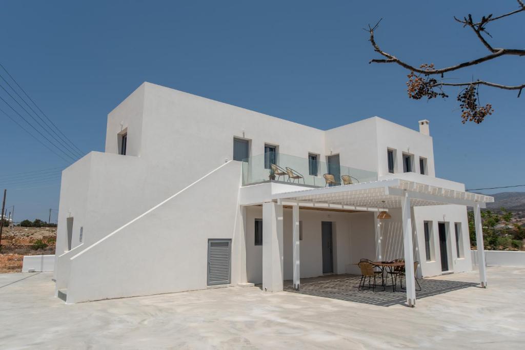 a white villa with a large patio at Villa Anastasio in Kampos Paros