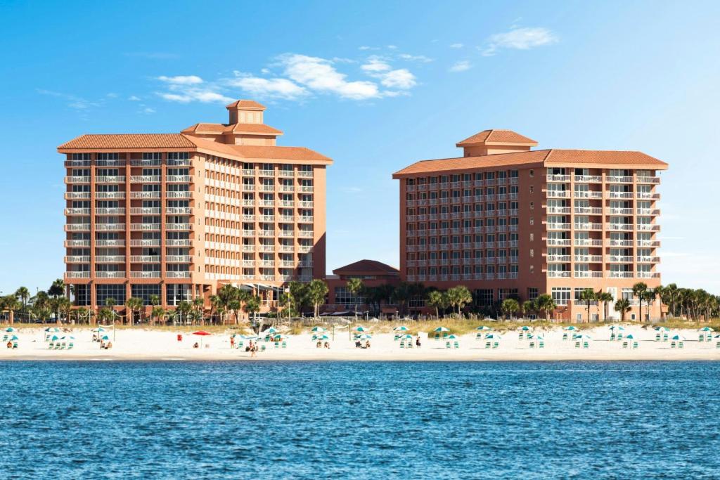 a beach with buildings and people on the beach at Perdido Beach Resort in Orange Beach