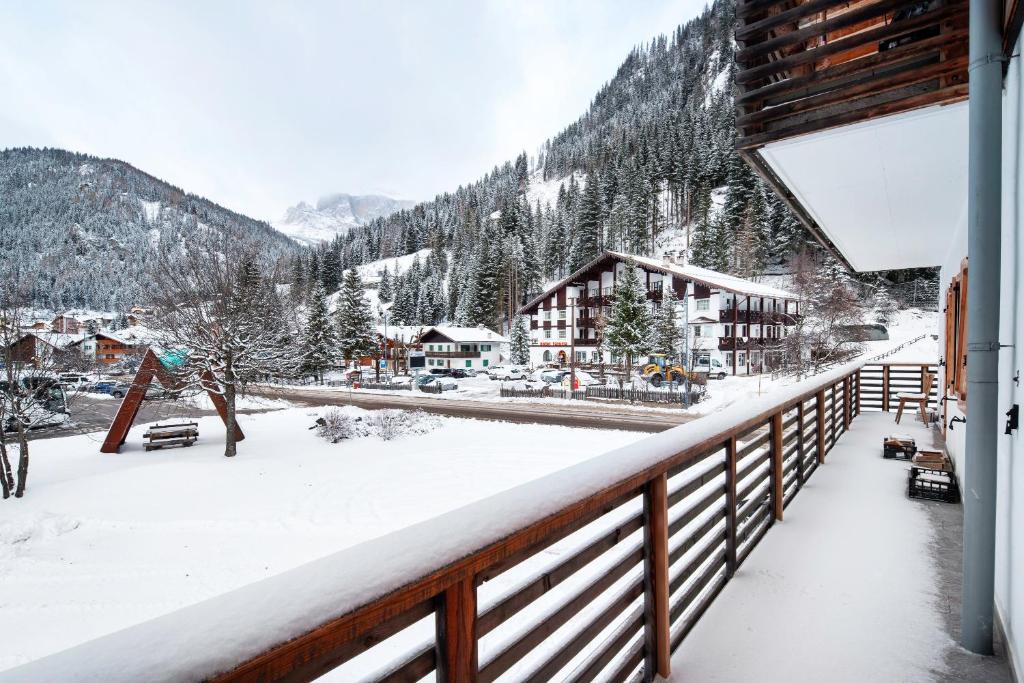 a balcony of a lodge with snow on the ground at Guesthouse Canazei Cozy 2-Bedrooms in Canazei