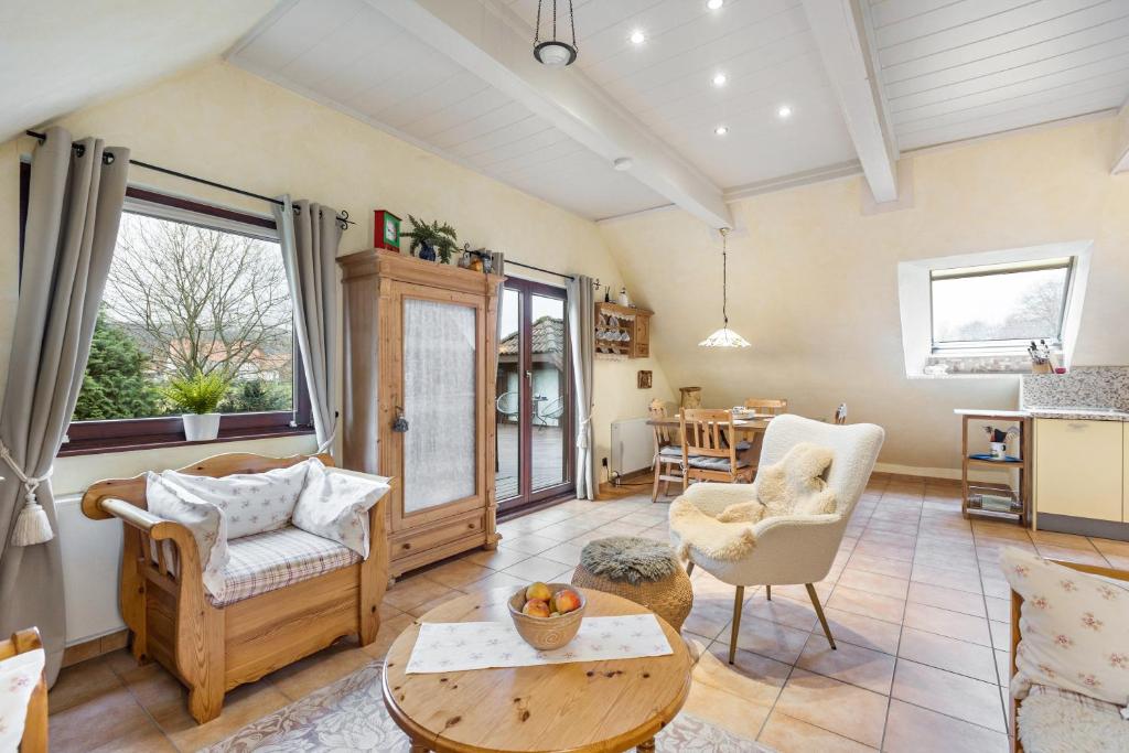 a living room with a couch and chairs and a table at Ferienwohnung Am Orpeturm in Marsberg