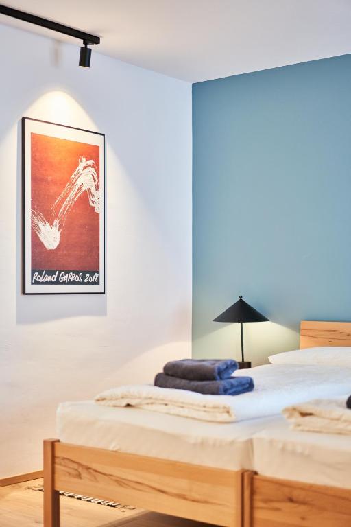 a bedroom with two beds and a picture on the wall at Alte Seifensiederei - Fabienne in Bad Tölz