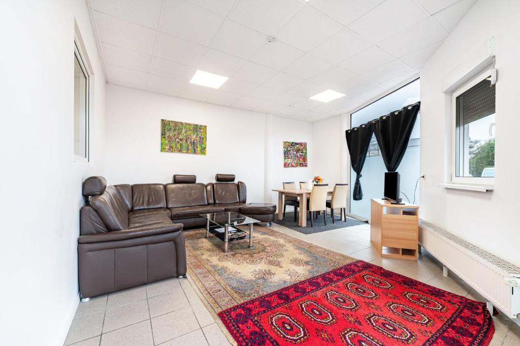 a living room with a couch and a table at Menzel Ferienwohnungen - W3 in Beckingen
