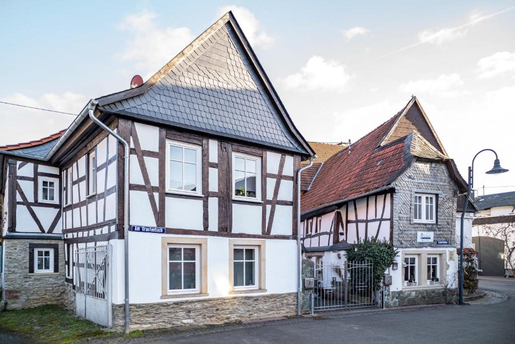 a white and black house with a brown roof at Wohnung 2 in Wallhausen