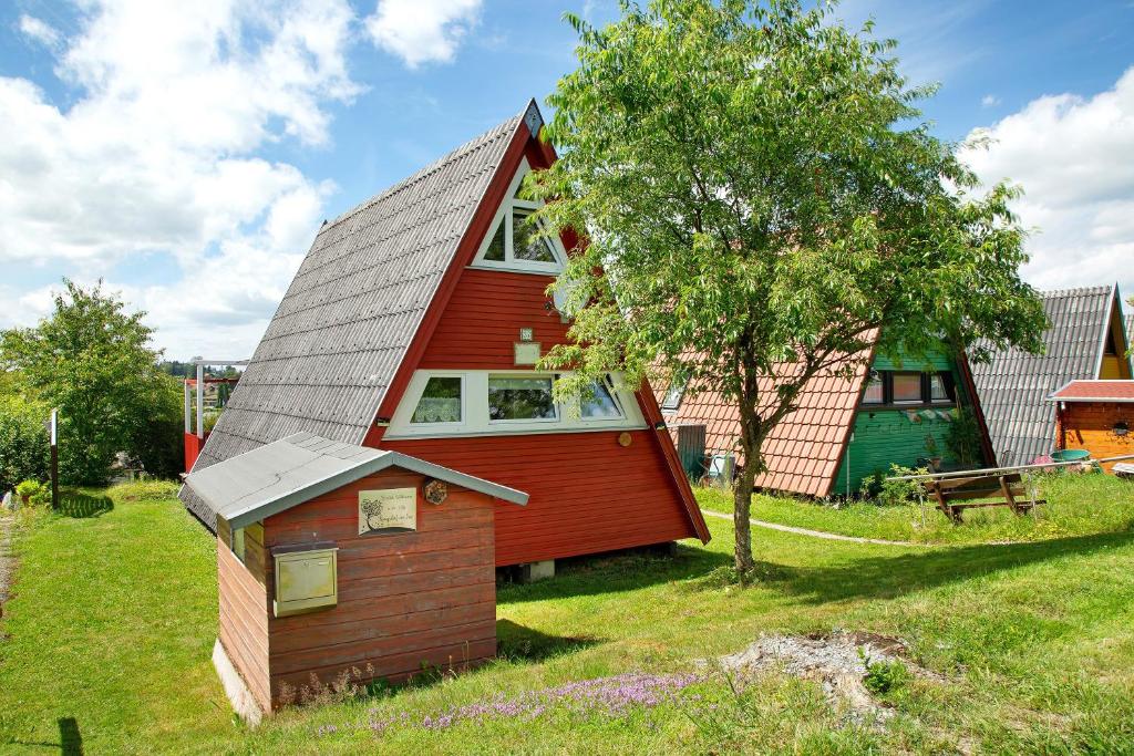 a small red house with a gambrel roof at Villa Königsdorf am See in Waldkirchen