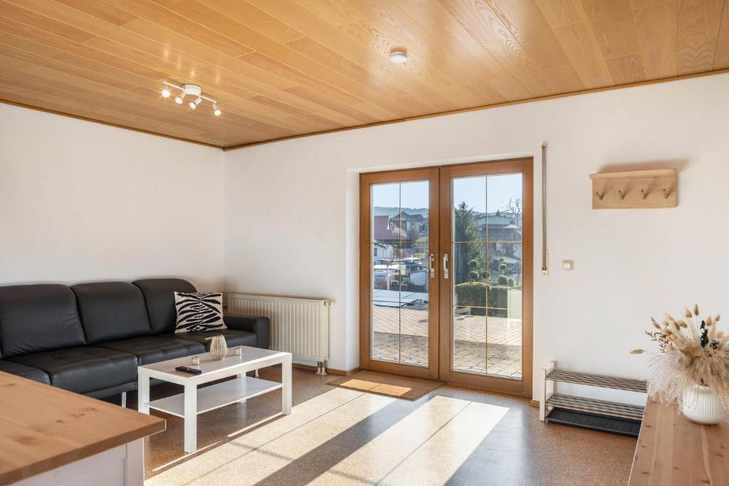 a living room with a couch and a table at Pension Stilletal - Springstille in Springstille