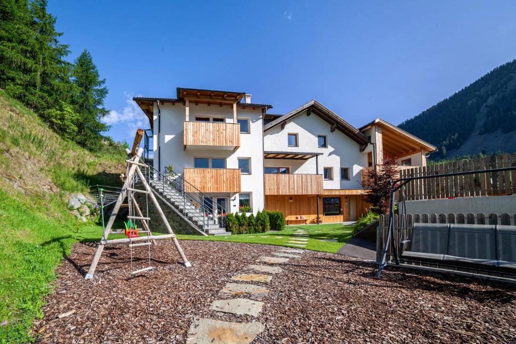 a house with a ladder in front of it at Mühlanderhof Apt Klopairspitze in Resia