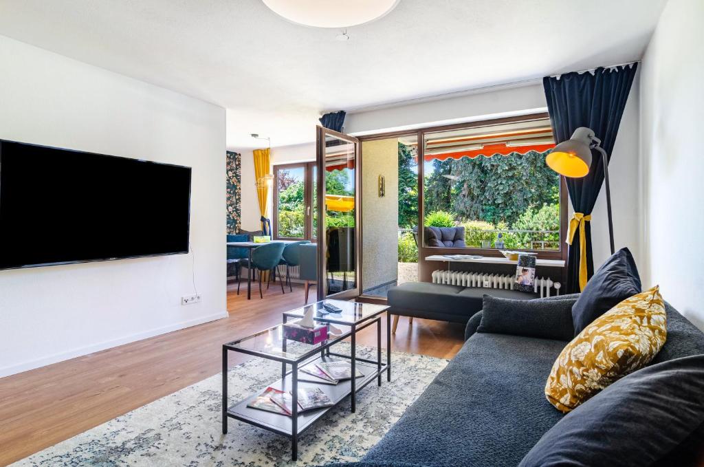 a living room with a couch and a tv at Schwabenseenestle in Uhldingen-Mühlhofen