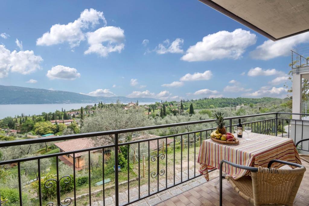 a table and chairs on a balcony with a view at Al Agave sotto in Toscolano Maderno