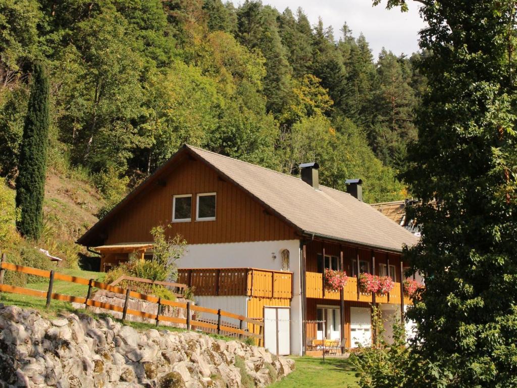 a brown and white house in the middle of a forest at Lorenz in Triberg