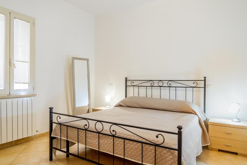a bedroom with a bed and a mirror at Acqua in Follonica