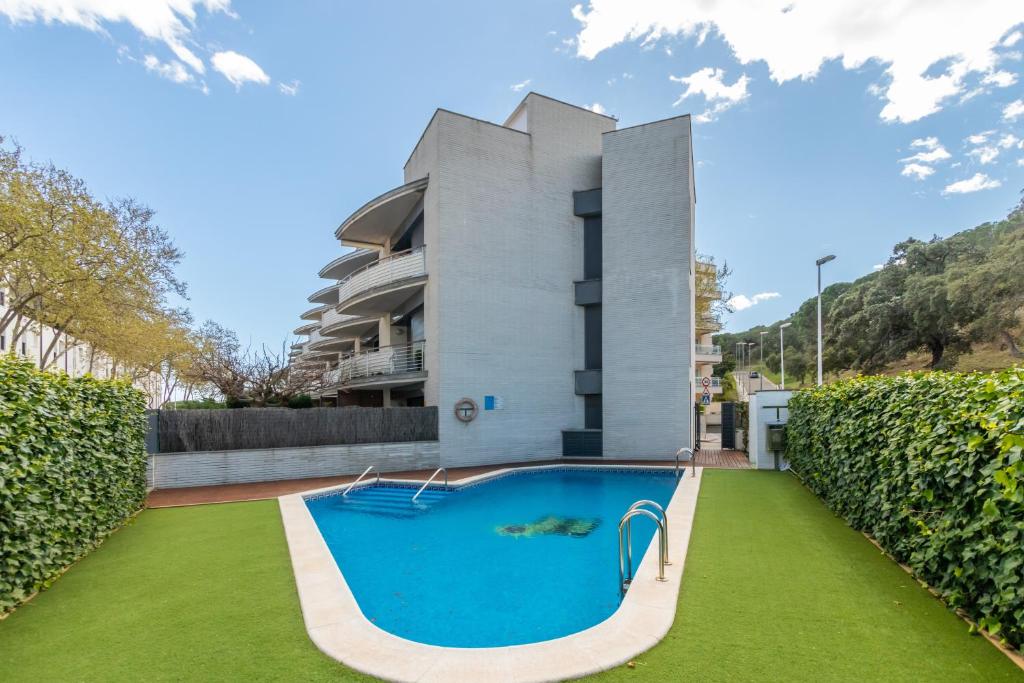an image of a swimming pool in front of a building at Mar i Llum in Platja d'Aro