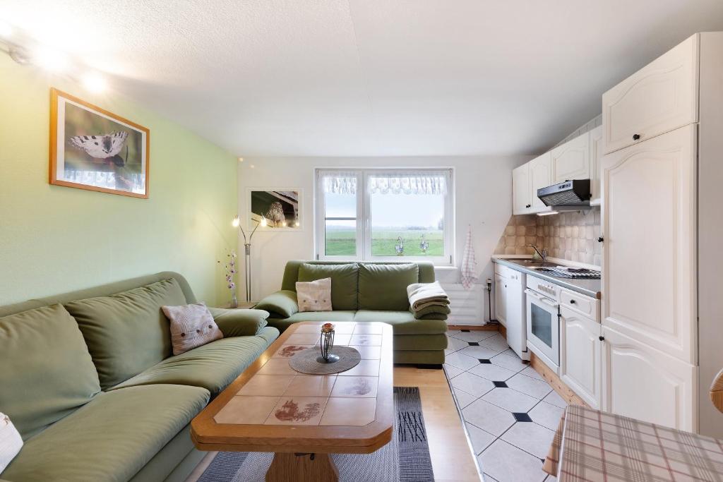 a living room with a couch and a table at Landferien Schütt in Neuenkirchen