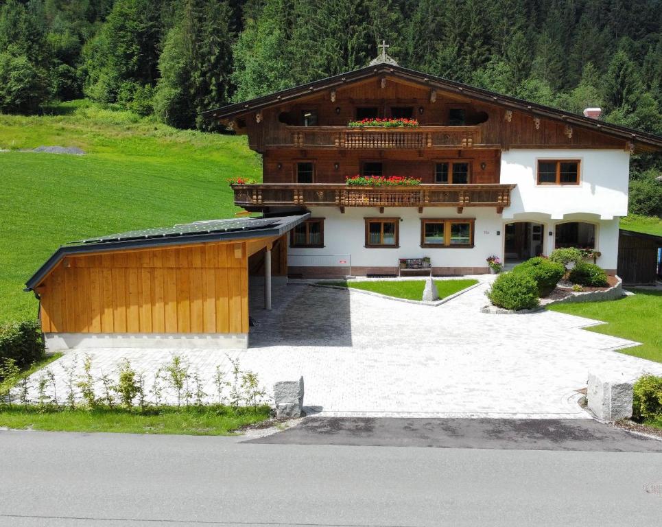 a large wooden building with a balcony on top of it at Apartment Bergglück Wildschönau in Wildschönau