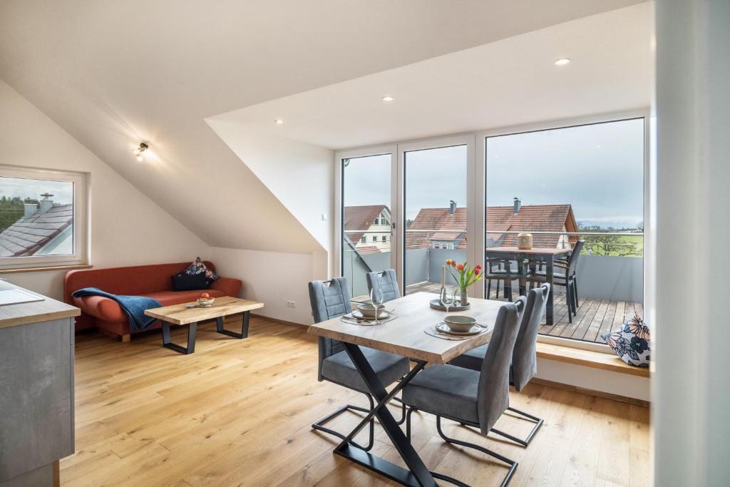 a kitchen and living room with a table and chairs at Blick zum Säntis in Horgenzell