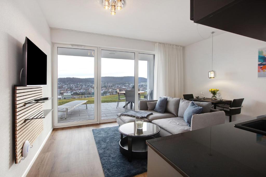a living room with a couch and a table at Ferienwohnung Panoramablick in Lörrach