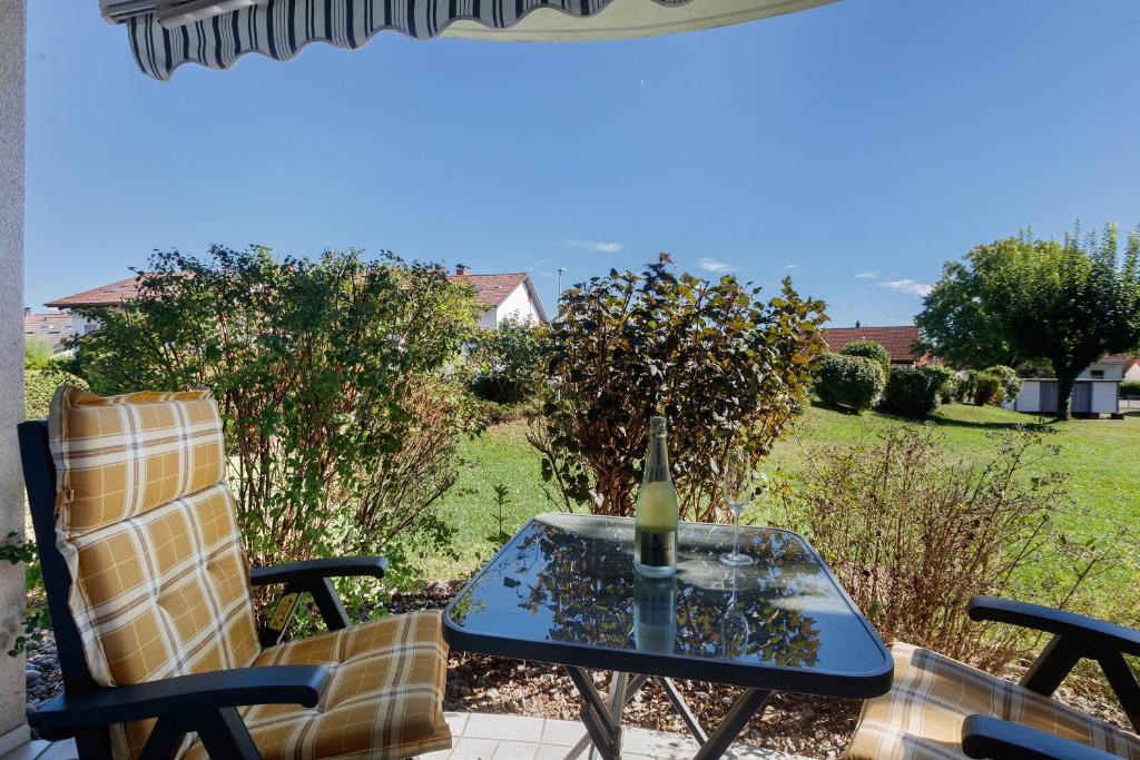 a table and chairs on a patio with a bottle of wine at Schweizer Grenze in Waldshut-Tiengen