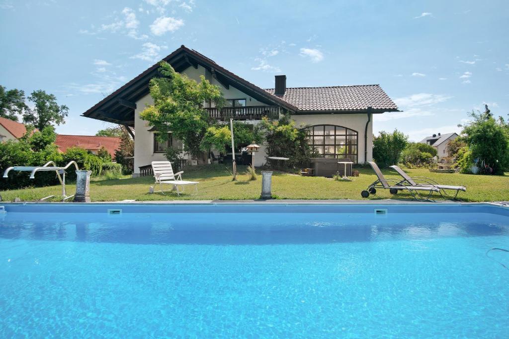 a house with a swimming pool in front of a house at Villa Galerie in Hohenwart