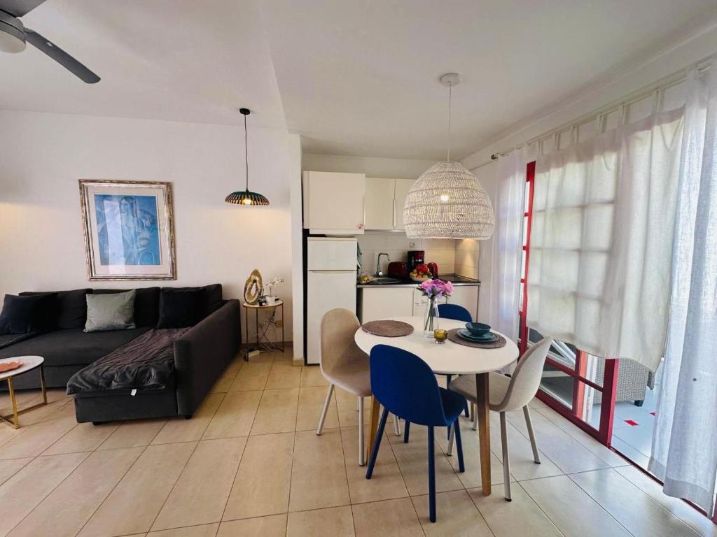a living room with a couch and a table at Bungalow Aloe Dunas 2 in Maspalomas