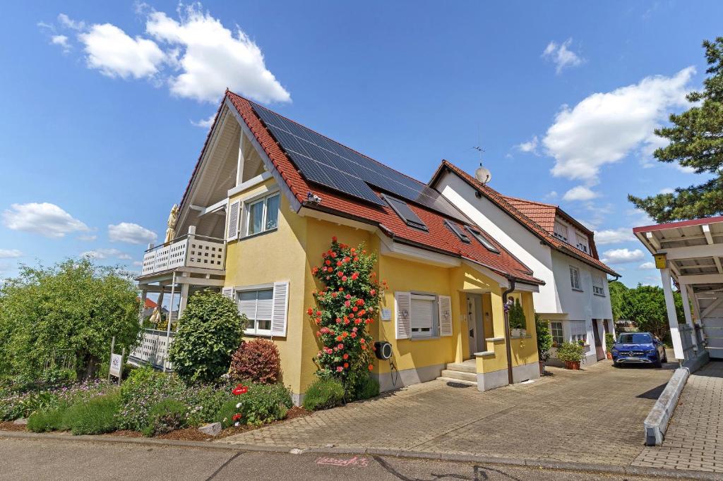 a yellow house with a christmas wreath on it at Ferienwohnungen Hog , Ringsheim in Ringsheim