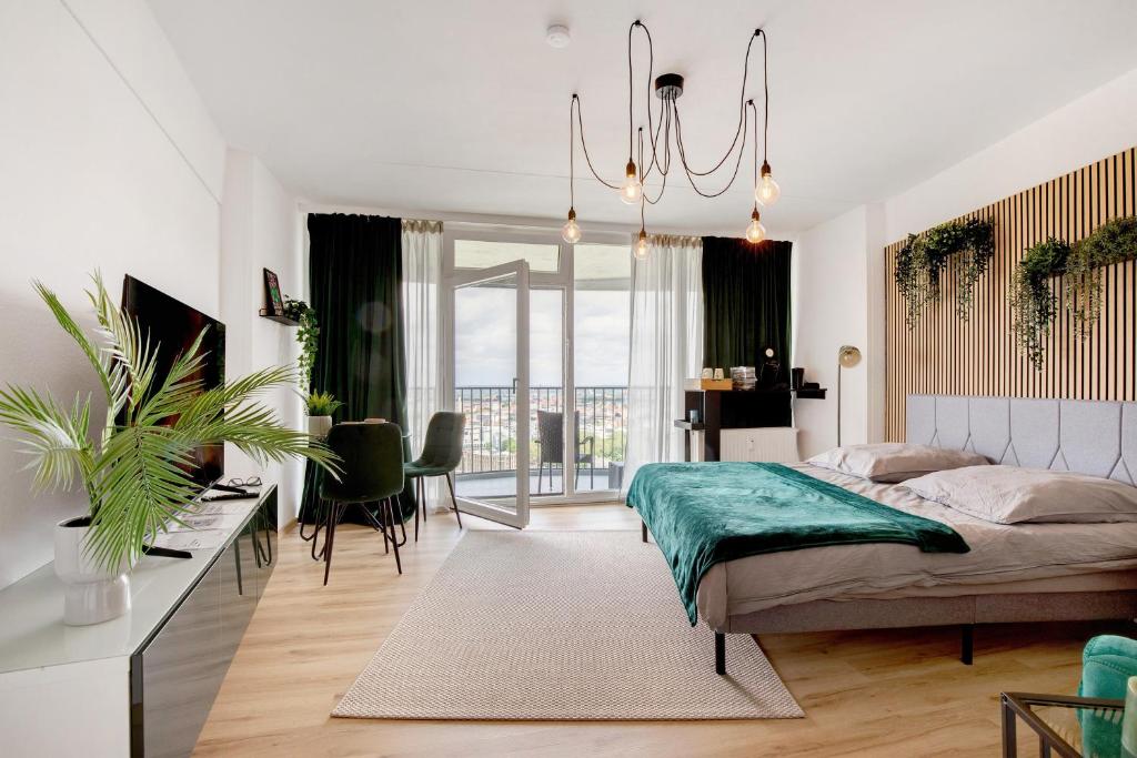a bedroom with a bed and a table and chairs at Global Bnb - Loft 28 Green in Augsburg