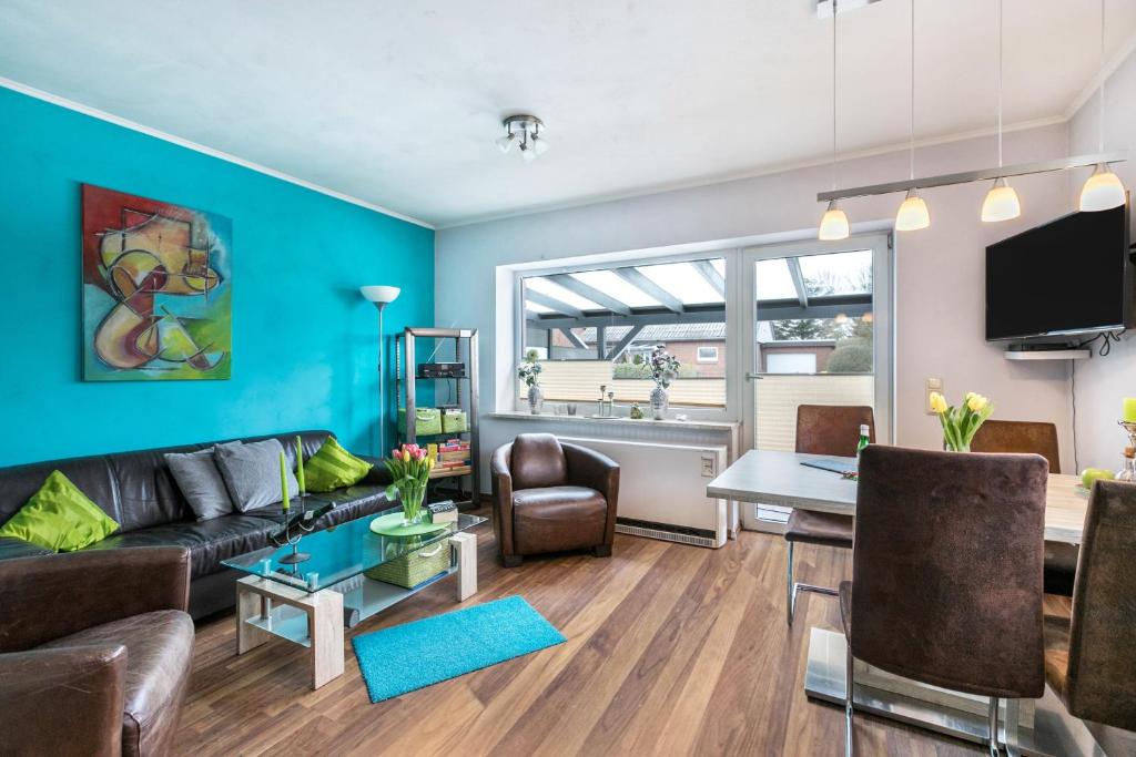 a living room with a couch and a table at Ferienhaus Ongi in Friedrichskoog-Spitze