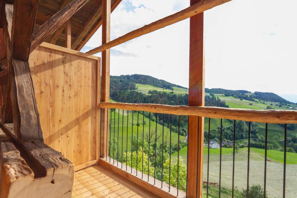 a room with a window with a view of the countryside at Daimlhof Ferienwohnung Moosherz in Völs am Schlern