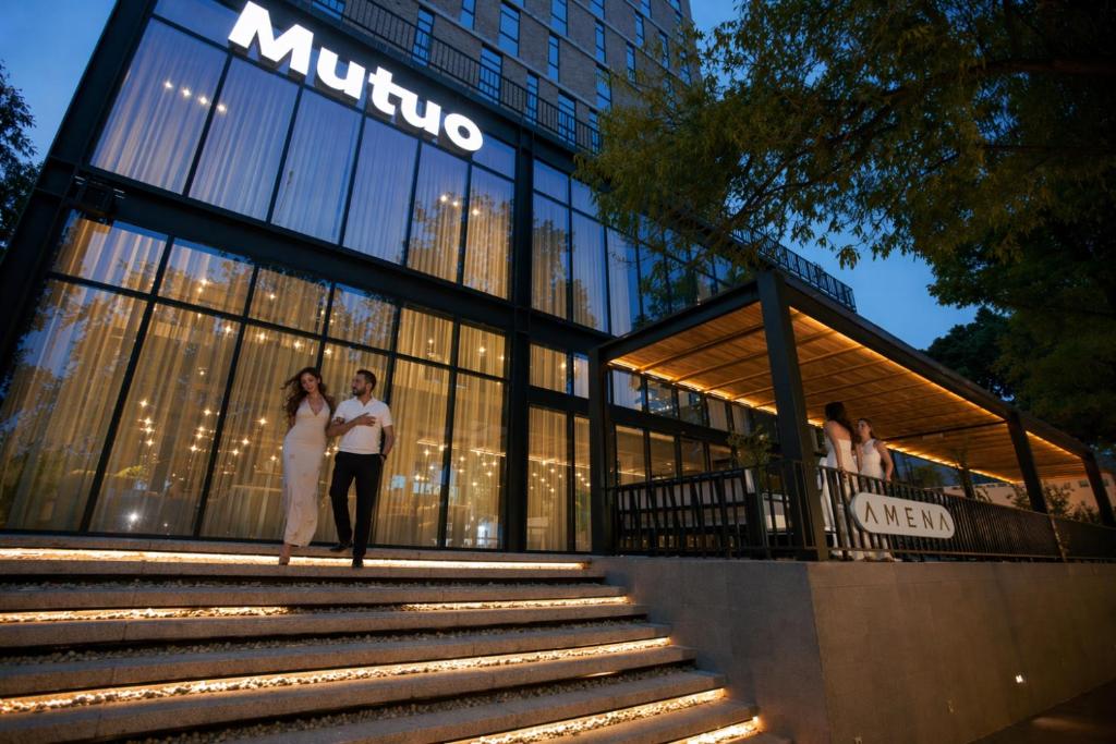 a couple standing in front of a building at Mutuo Vive in Guadalajara